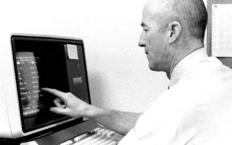 Larry Weed using Megadata Terminal, ca. 1980.